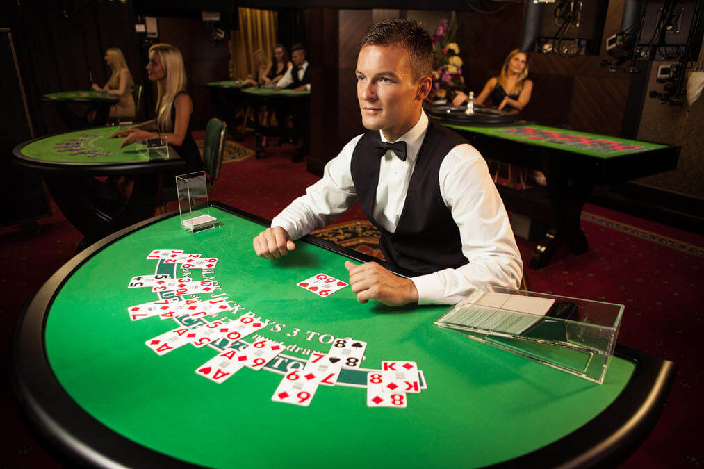 A live casino dealer and blackjack table